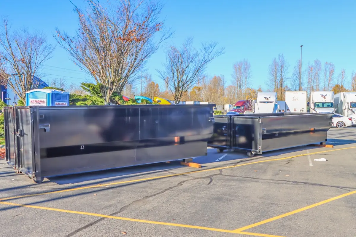 Professional dumpster rental service with roll-off container on residential driveway in Blackhawk